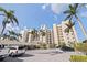Exterior view of modern condo building with palm trees and parking; a blend of style and practicality at 6105 Bahia Del Mar Cir # 683, St Petersburg, FL 33715
