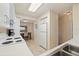 Galley kitchen featuring white appliances, tile flooring, and access to dining area at 6105 Bahia Del Mar Cir # 683, St Petersburg, FL 33715