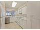 Bright kitchen with ample white cabinets, modern appliances, and a view, a functional and stylish space at 6105 Bahia Del Mar Cir # 683, St Petersburg, FL 33715