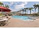 Resort-style pool area surrounded by swaying palm trees, lounge chairs, and umbrellas for ultimate relaxation and outdoor enjoyment at 6105 Bahia Del Mar Cir # 683, St Petersburg, FL 33715