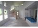 Spacious, unfinished interior with high ceilings, staircase, and large windows providing ample natural light at 648 Allora Ave, Nokomis, FL 34275