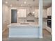 Modern kitchen with white cabinetry, stainless steel appliances, and a large island at 648 Allora Ave, Nokomis, FL 34275