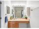 Bathroom featuring a vanity with a built-in seat, complemented by decorative plants and vanity lighting at 6541 Black Mangrove Dr, Largo, FL 33773