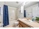 Clean bathroom with a shower-tub combo, a wooden vanity and a mirror at 6541 Black Mangrove Dr, Largo, FL 33773