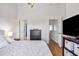 Bright bedroom features a ceiling fan, a dresser, and an ensuite bathroom at 6541 Black Mangrove Dr, Largo, FL 33773