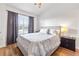 Well-lit bedroom features a queen-sized bed, dark wood furniture, and natural light from the window at 6541 Black Mangrove Dr, Largo, FL 33773