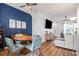 Cozy dining area adjacent to the living room featuring a round table, blue accent wall, and stylish furnishings at 6541 Black Mangrove Dr, Largo, FL 33773
