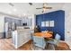 Dining area with stainless steel appliances, a round wood table, seating for four, and a stylish blue accent wall at 6541 Black Mangrove Dr, Largo, FL 33773