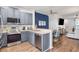 Open-concept kitchen with stainless steel appliances, gray cabinets, and a view into the dining and living areas at 6541 Black Mangrove Dr, Largo, FL 33773