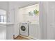Laundry room features a washer, a dryer and storage shelves at 6541 Black Mangrove Dr, Largo, FL 33773