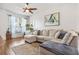 Bright and inviting living room featuring a comfortable sectional sofa, hardwood floors, and stylish decor at 6541 Black Mangrove Dr, Largo, FL 33773