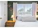 Bright bedroom featuring a window with natural light, complemented by stylish décor and tasteful accents at 6541 Black Mangrove Dr, Largo, FL 33773