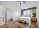 Cozy main bedroom with a large window, ensuite bathroom, and minimalist decor at 6541 Black Mangrove Dr, Largo, FL 33773