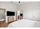 Comfortable bedroom with a TV, ensuite bath, closet, and a standing mirror at 6541 Black Mangrove Dr, Largo, FL 33773