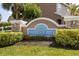 Community signage for Hidden Creek, surrounded by lush landscaping and manicured bushes at 6541 Black Mangrove Dr, Largo, FL 33773