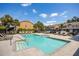 Community pool with several lounge chairs and surrounding palm trees at 6541 Black Mangrove Dr, Largo, FL 33773