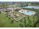 Aerial view of community pool and playground next to a parking lot at 6937 Gideon Cir, Zephyrhills, FL 33541