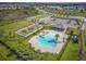 Aerial view of community amenities including pool, playground, and green spaces at 6937 Gideon Cir, Zephyrhills, FL 33541