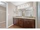 Bathroom showcasing double vanity with granite countertop and modern fixtures at 6937 Gideon Cir, Zephyrhills, FL 33541