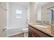 Bathroom featuring a granite countertop, white tiled walls, and wood-look floors at 6937 Gideon Cir, Zephyrhills, FL 33541