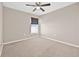 Neutral bedroom featuring carpet, a ceiling fan, a window with blinds, and an electrical outlet at 6937 Gideon Cir, Zephyrhills, FL 33541