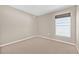 Bright, carpeted bedroom with neutral walls and a window at 6937 Gideon Cir, Zephyrhills, FL 33541