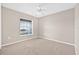 Cozy bedroom featuring neutral walls, plush carpeting, and natural light at 6937 Gideon Cir, Zephyrhills, FL 33541