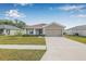 Charming single-story home boasts a well-maintained lawn and a two-car garage, enhancing curb appeal at 6937 Gideon Cir, Zephyrhills, FL 33541