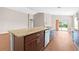 Open-concept kitchen with a large island, stainless steel appliances, and seamless access to the living area at 6937 Gideon Cir, Zephyrhills, FL 33541