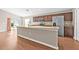 Well-equipped kitchen with granite countertops, wood cabinets, stainless steel appliances, and eat-in area at 6937 Gideon Cir, Zephyrhills, FL 33541