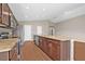 Modern kitchen features granite countertops, stainless steel appliances, a large island, and ample cabinet space at 6937 Gideon Cir, Zephyrhills, FL 33541