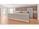 Modern kitchen features an island, stainless steel appliances, and dark wood cabinetry at 6937 Gideon Cir, Zephyrhills, FL 33541