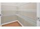 Organized walk-in closet with ample shelving for efficient storage and organization at 6937 Gideon Cir, Zephyrhills, FL 33541