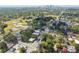 Aerial view of a residential area featuring a mix of housing, green spaces, and city skyline at 702 W Virginia Ave, Tampa, FL 33603