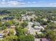 A scenic aerial of a neighborhood with mature trees and traditional-style homes at 702 W Virginia Ave, Tampa, FL 33603