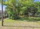 A lot with mature trees and partial fence with potential for building or recreating at 702 W Virginia Ave, Tampa, FL 33603