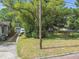 Rear view of property showing the back yard and access to the detached garage via long driveway at 702 W Virginia Ave, Tampa, FL 33603