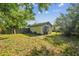 Exterior view of the backyard featuring a detached building and a fence at 702 W Virginia Ave, Tampa, FL 33603