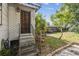 Entry stairs leading to a detailed wood front door and backyard at 702 W Virginia Ave, Tampa, FL 33603