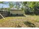 Exterior view of the backyard featuring a detached building and a fence at 702 W Virginia Ave, Tampa, FL 33603