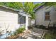 Exterior view of the backyard featuring a detached building, fence, and the side of the home at 702 W Virginia Ave, Tampa, FL 33603