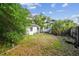 Exterior view of the backyard featuring a detached building, house and grass at 702 W Virginia Ave, Tampa, FL 33603