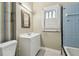 Bathroom features a white vanity and a bathtub with tile surround at 702 W Virginia Ave, Tampa, FL 33603