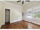 Bedroom features hardwood floors, natural lighting, and closet at 702 W Virginia Ave, Tampa, FL 33603