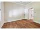 Light filled room with original hardwood floors and neutral paint at 702 W Virginia Ave, Tampa, FL 33603
