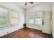 This bedroom has hardwood floors, two windows that provide natural light, and a door at 702 W Virginia Ave, Tampa, FL 33603