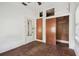 The bedroom has hardwood floors, built-in closets, a ceiling fan, and a window that provides natural light at 702 W Virginia Ave, Tampa, FL 33603