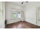 This bedroom has hardwood floors, windows that provide natural light, and a door at 702 W Virginia Ave, Tampa, FL 33603
