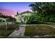 Charming exterior view of home with a front porch, landscaping, driveway, and blue skies above at 702 W Virginia Ave, Tampa, FL 33603