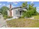 Home's exterior showcasing mature landscape, porch, and side of the house with vintage details at 702 W Virginia Ave, Tampa, FL 33603